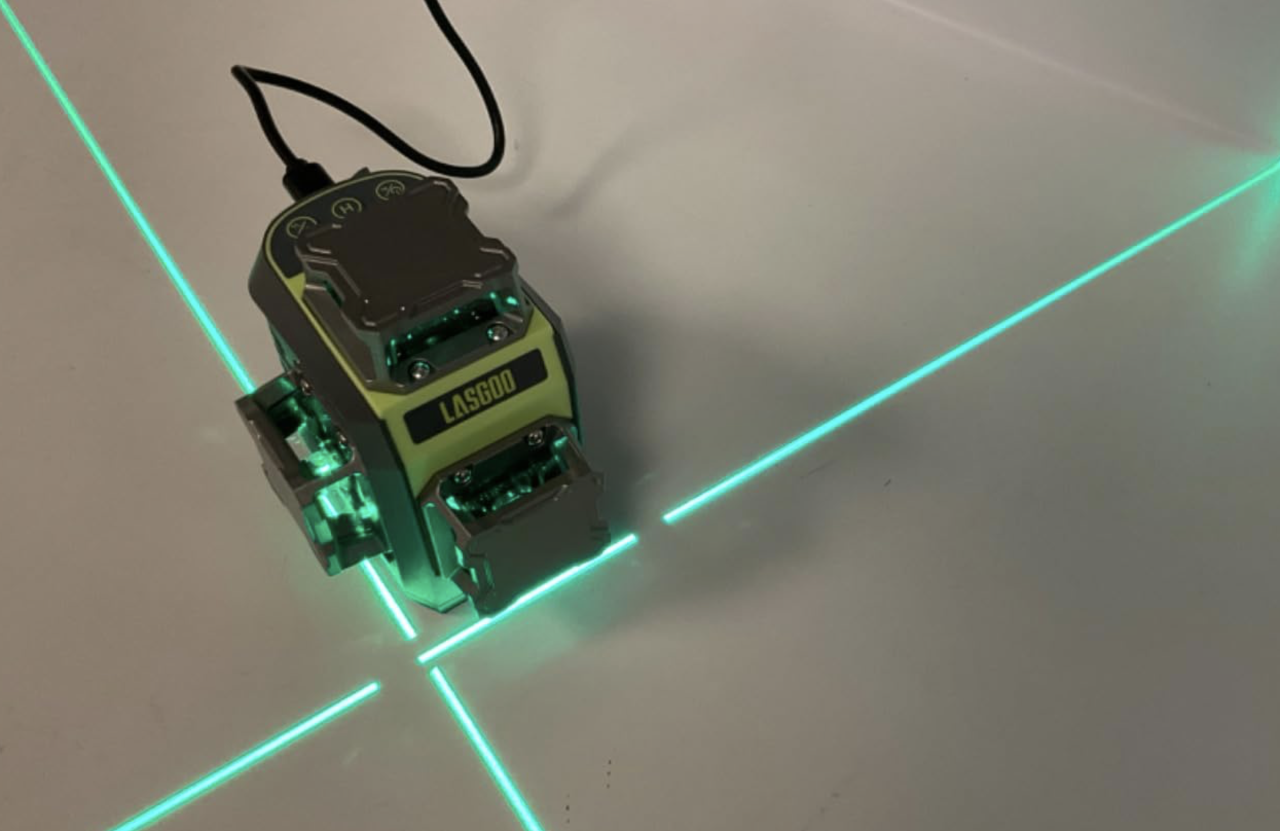 LG-3Dx laser level emitting one horizontal and two vertical green laser lines, covering every corner of a room.
